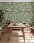 Wooden dining table and chairs situated within the dining area, backed by a wall displaying a leaf design