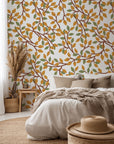 A botanical pattern wallpaper featuring a white background, accented by golden and green foliage