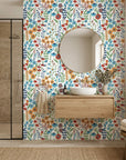 Amber Poppy vibrant floral peel and stick wallpaper as a feature wall in a bright home office