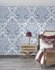 Blue and white Amber Blossom Ballet damask wallpaper in elegant bedroom with ornate scrollwork pattern