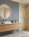 Anchor Chain navy geometric peel and stick wallpaper creating ambiance in a serene bathroom