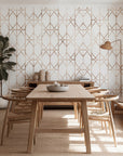 Wallpaper product displaying warm rose gold repeating lines that form a geometric lattice design, set against a gentle white surface