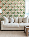 Lush green repeating toile pattern wallpaper illustrating tropical trees and neo-classical building elements