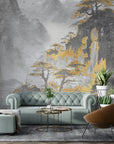 Gold and gray Asian Mountains wallpaper with misty landscape behind sage green tufted sofa