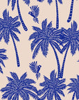 Tropical palm tree wallpaper pattern with hand illustrated palm trees and birds in deep blue on a warm neutral background.
