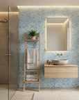 Blue Mirage coastal abstract peel and stick wallpaper creating ambiance in a serene bathroom