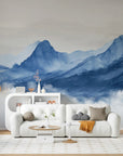 Blue Mountains watercolor wallpaper with gradient peaks and clouds on modern living room accent wall