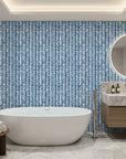 Blue Stitching navy and white chevron herringbone wallpaper creating ambiance in a serene bathroom