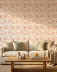 Blush Frond peach botanical peel and stick wallpaper in a warm and inviting living room