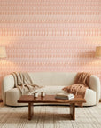 Blush Ikat peach and pink abstract wallpaper adding character to a cozy bedroom