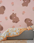 Whimsical capybara pattern with delicate rose-colored flowers on removable vinyl wallpaper - Blush Blooms