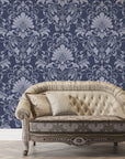 Navy and silver Blushed Whisper damask wallpaper behind elegant tufted sofa in luxury living room