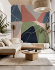 Wallpaper design showing overlapping, flowing organic shapes. This mid-century modern abstract piece features colors like navy, sage green, blush pink, and pale gray, complete with delicate intersecting lines.