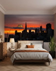 Orange and gray Burning Horizon cityscape mural wallpaper on contemporary bedroom accent wall
