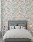 Vibrant rainbow speckled waves decorate this self-adhesive wall covering. - Candy Currents