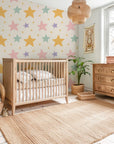 Peel-and-stick wall covering in a cream hue featuring a pattern of soft, multi-hued stars and glinting celestial details. - Celestial Dream