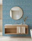 Cerulean Garden distressed geometric wallpaper creating ambiance in a serene bathroom