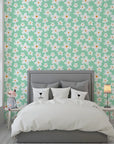 Self-adhesive wallpaper featuring white crayon-style daisies over a soft mint green backdrop. - Chalky Meadow