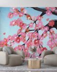 Pink cherry blossom branches on blue sky removable wallpaper in modern living room