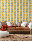 Geometric tiled wall covering featuring yellow lemons and fresh green leaves. Citrus Bloom design.