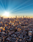 Golden hour Manhattan skyline City Ablaze wallpaper with dramatic sunburst over urban landscape