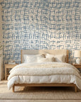 Concrete Drift blue & grey abstract wallpaper adding character to a cozy bedroom