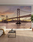 San Francisco Bay Bridge at sunset mural wallpaper in modern minimalist living room with warm amber tones