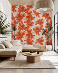 The 'Coral Whispers' wallcovering featuring stylized botanical elements; translucent leaves in orange and coral hues.