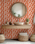Transparent orange and coral leaves create the pattern on this abstract floral wallpaper, named Coral Whispers