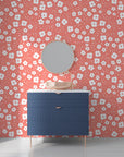 Delicate miniature blossoms scattered across a soft coral-hued removable vinyl surface - Coral Cascade