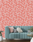 Vibrant peach-toned tiny wildflower motif on a flat, non-textured decorative wallpaper - Coral Cascade