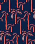 Deep blue wallpaper adorned with vibrant coral palm trees. Tropical 'Coral Sway' design