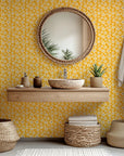Whimsical wallcovering in mustard yellow featuring a cream hand-drawn floral motif (Cosmic Bloom)