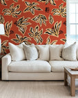 Artistic black floral sketches on a rust orange abstract peel and stick wallpaper