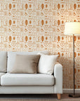A decorative background pattern of arid land motifs, including horseshoes, serpents, lunar shapes, and Western boots, all rendered in warm, earthy clay colors
