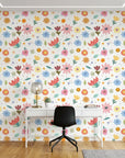 Dotted Bliss white whimsical folk art floral wallpaper as a feature wall in a bright home office