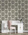 Dreamy Fern Dial damask wallpaper with charcoal florals on cream background behind white vanity desk