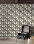 Classic damask wallpaper with charcoal gray ornate motifs on cream background in styled living room