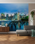 Manhattan skyline Driftwood & Dreams wallpaper mural with illuminated buildings reflected in blue harbor waters