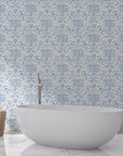 Powder blue and cream Dusky Garden Waltz damask wallpaper behind modern freestanding bathtub