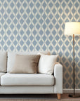 The gentle azure ikat wallpaper exhibits a recurring motif of diffuse lozenge shapes against a backdrop of pale ecru.