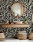 A removable, self-adhesive wallpaper featuring a black and ivory floral silhouette design, called Ebony Garden