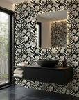 Ebony Garden black and cream floral silhouette wallpaper creating ambiance in a serene bathroom