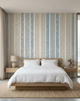 Ecliptic Flow blue grey distressed stripe wallpaper adding character to a cozy bedroom