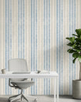 Ecliptic Flow blue grey distressed stripe wallpaper as a feature wall in a bright home office
