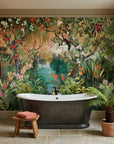 Lush tropical Eden Revealed wallpaper with exotic birds and foliage behind freestanding bathtub in spa bathroom