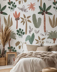 Soft pastel green and pink palm leaves on a bohemian nursery peel and stick wallpaper