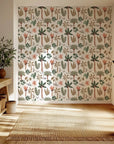 Soft pastel green and pink palm leaf wallpaper in a bohemian nursery style with easy peel and stick application