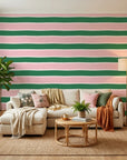 Ember Blush pink and green horizontal stripe wallpaper in a warm and inviting living room