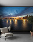 Embers On The Horizon wallpaper mural featuring twilight city skyline with golden reflections on water in modern living room